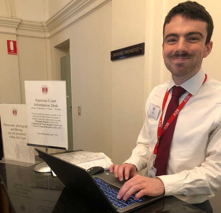 A Supreme Court staff member acting as concierge at the Supreme Court entrance of 210 William Street.