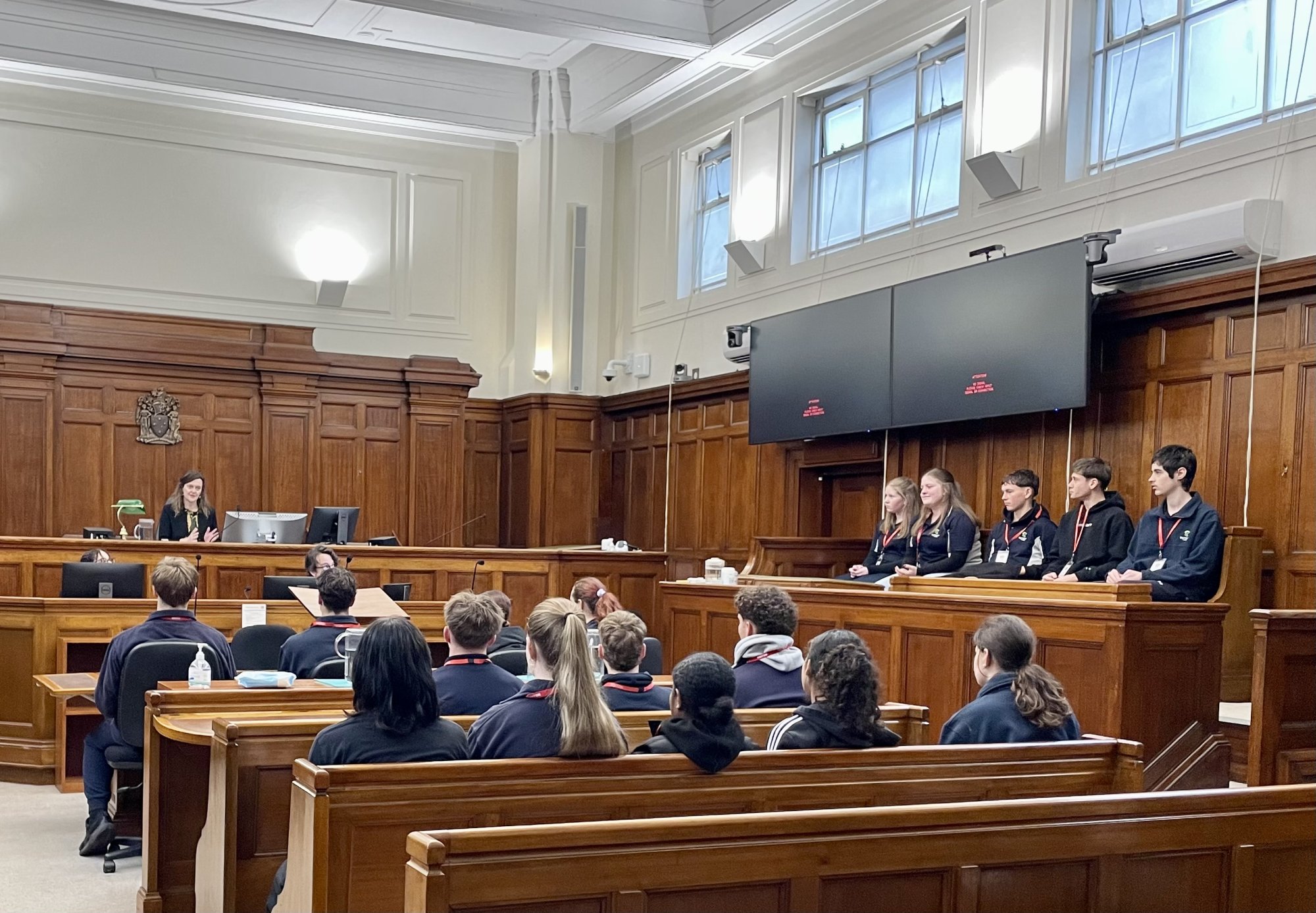 Photo of Seymour College students in a court room meeting with Justice Claire Harris August 2026