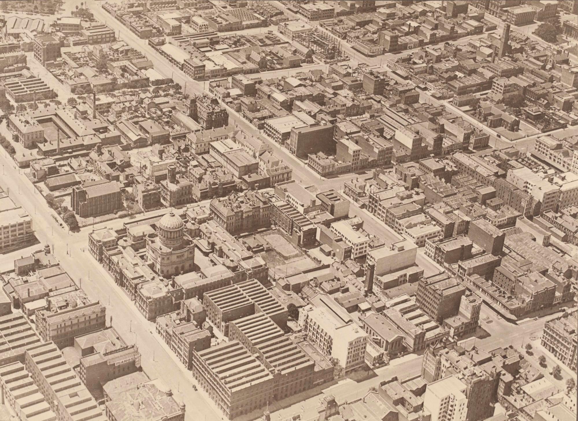 Black and white photograph showing an aerial view of Melbourne city showing. The image, taken in the early 1920's, show the Supreme Court amongst the other city buildings.